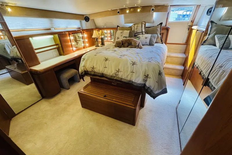 Slide: The Image of Luxurious bedroom interior of 1991 Californian 55 Cockpit Motor Yacht with elegant decor. - 7
