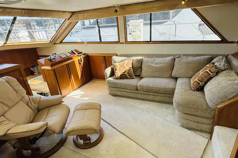 Slide: The Image of Luxurious interior of 1991 Californian 55 Cockpit Motor Yacht with plush seating and panoramic windows. - 71