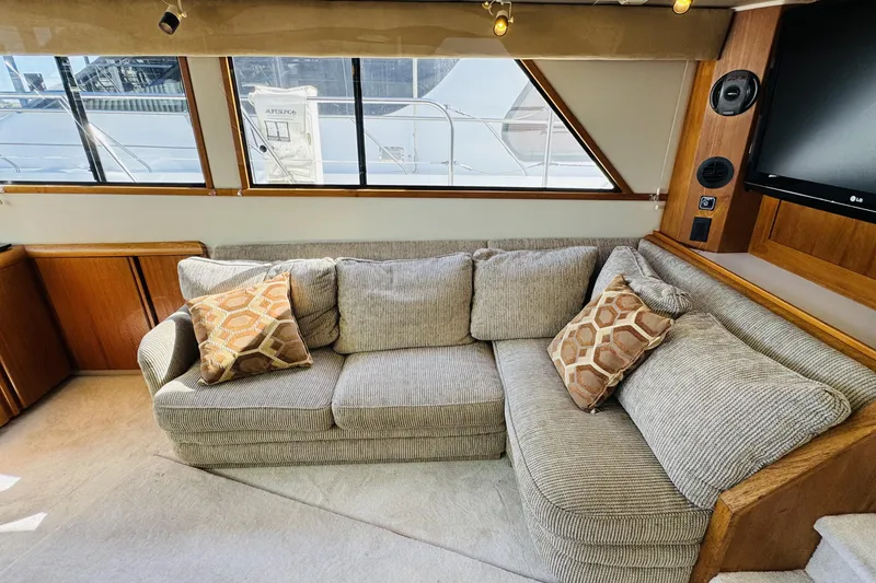 Slide: The Image of Luxurious interior of 1991 Californian 55 Cockpit Motor Yacht with cozy sofa and cushions. - 73