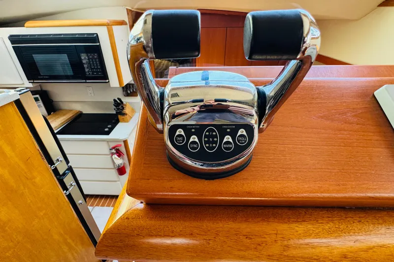 Slide: The Image of Throttle controls on 1991 Californian 55 Cockpit Motor Yacht, with kitchen in background. - 80