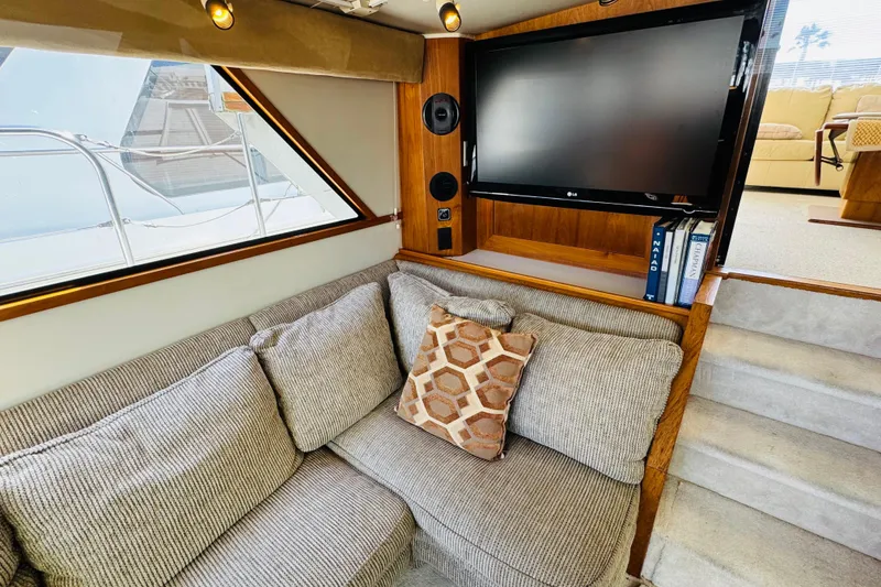 Slide: The Image of Luxurious interior of 1991 Californian 55 Cockpit Motor Yacht with cozy seating and TV. - 81