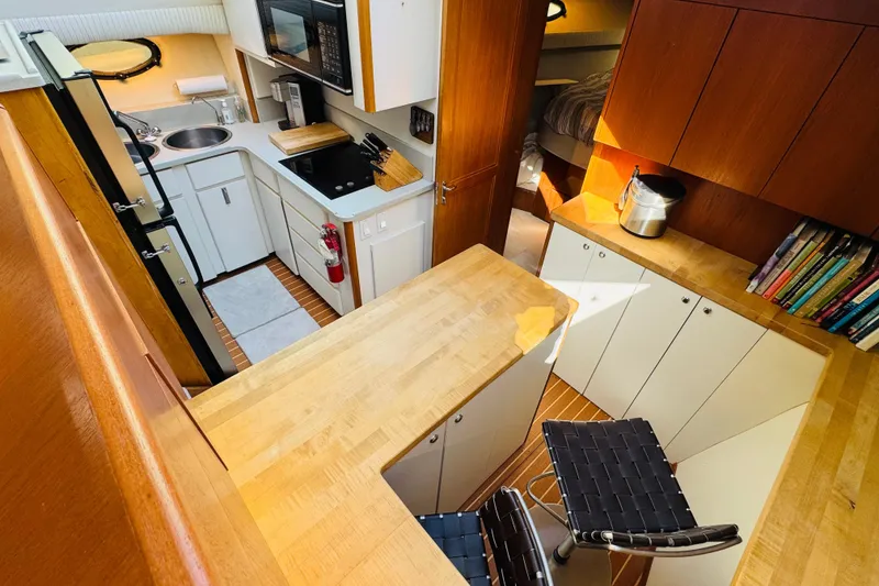Slide: The Image of Interior of 1991 Californian 55 Cockpit Motor Yacht with kitchen and seating area. - 82