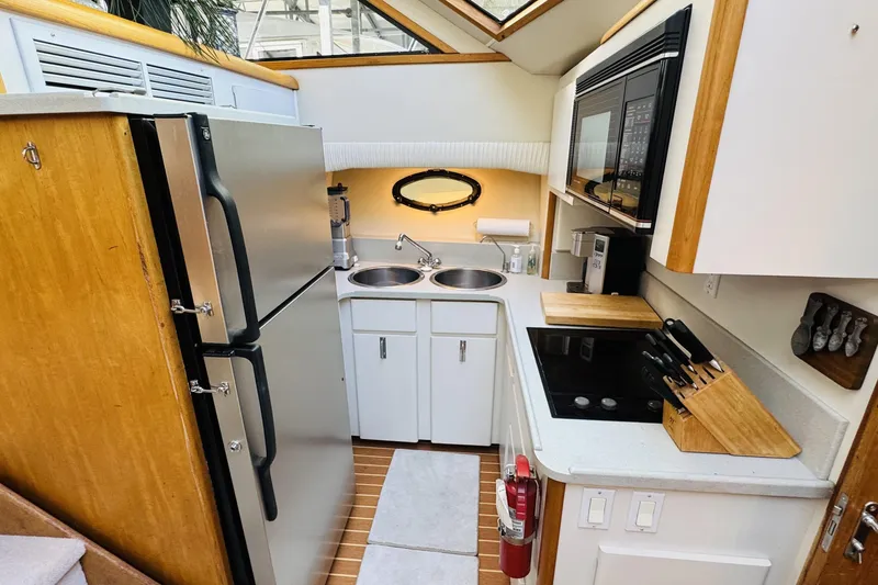 Slide: The Image of 1991 Californian 55 Cockpit Motor Yacht kitchen with modern appliances and wooden accents. - 83