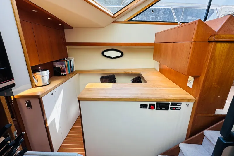 Slide: The Image of Interior of 1991 Californian 55 Cockpit Motor Yacht with wooden cabinetry and skylight. - 87