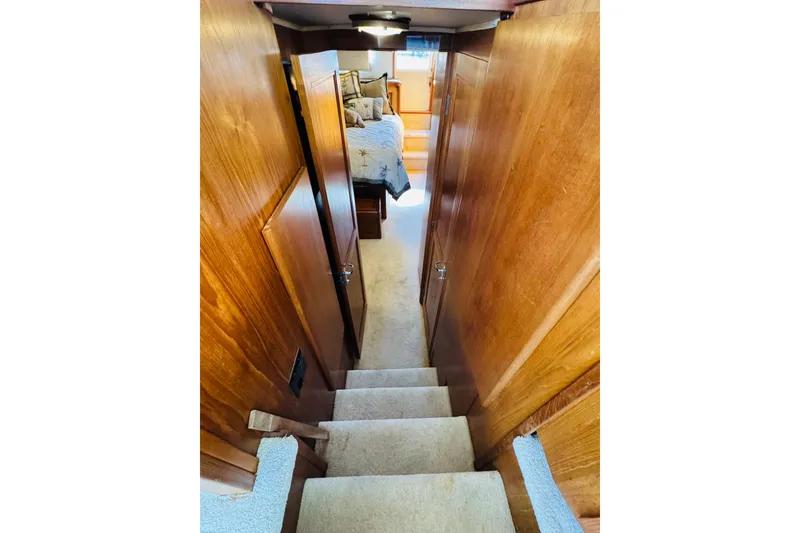 Slide: The Image of Interior view of 1991 Californian 55 Cockpit Motor Yacht with wooden walls and carpeted stairs. - 89