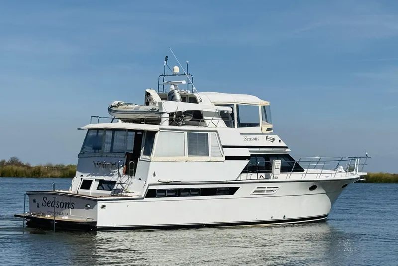Slide: The Image of 1991 Californian 55 Cockpit Motor Yacht on calm water under clear sky. - 9