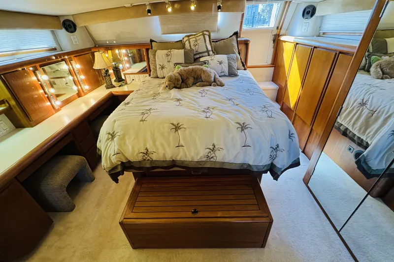 Slide: The Image of Luxurious bedroom interior of 1991 Californian 55 Cockpit Motor Yacht with elegant decor. - 91