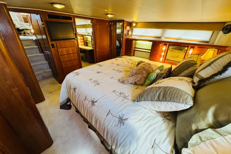 Slide: The Image of Luxurious bedroom interior of 1991 Californian 55 Cockpit Motor Yacht with plush bedding. - 95