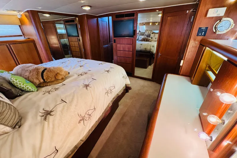 Slide: The Image of Luxurious bedroom in 1991 Californian 55 Cockpit Motor Yacht with cozy bedding and plush decor. - 96