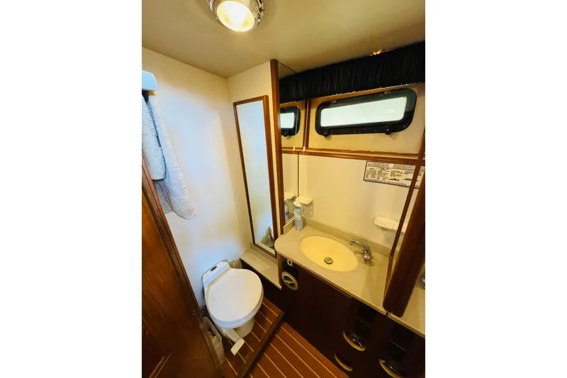 Slide: The Image of Bathroom interior of 1991 Californian 55 Cockpit Motor Yacht with sink and toilet. - 99