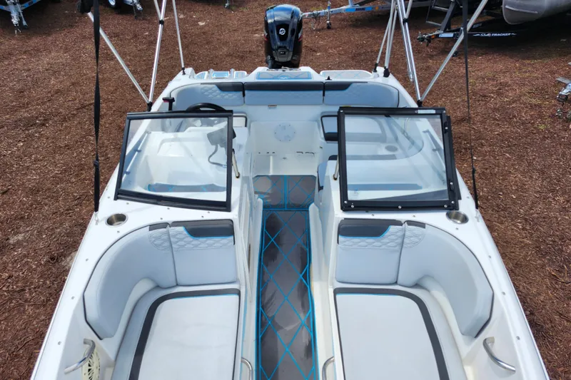 Slide: The Image of 2023 Bayliner Element M17 boat interior with seating and windshield, parked on mulch. - 11