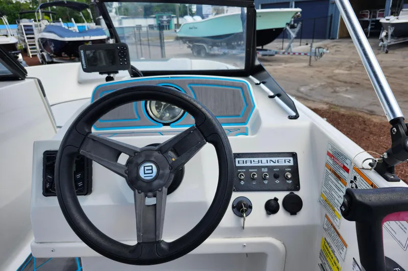 Slide: The Image of 2023 Bayliner Element M17 dashboard with steering wheel and control panel. - 20
