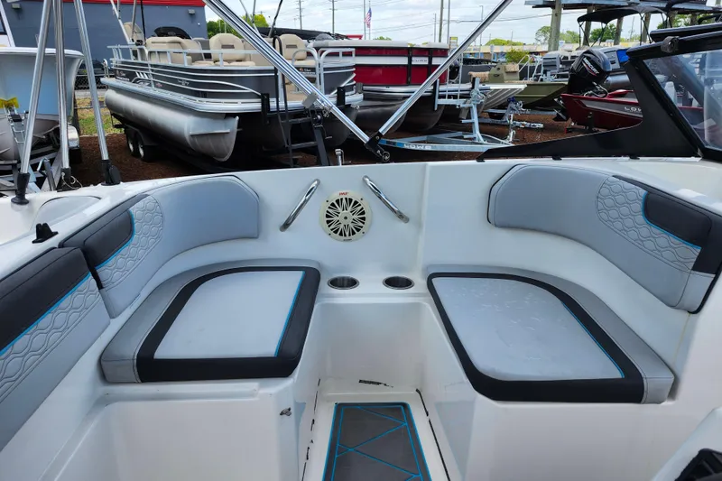 Slide: The Image of 2023 Bayliner Element M17 boat interior with cushioned seating and cup holders. - 21