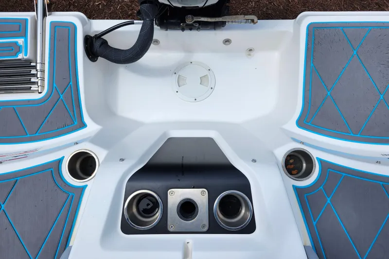 Slide: The Image of 2023 Bayliner Element M17 boat deck with cup holders and blue accents. - 25