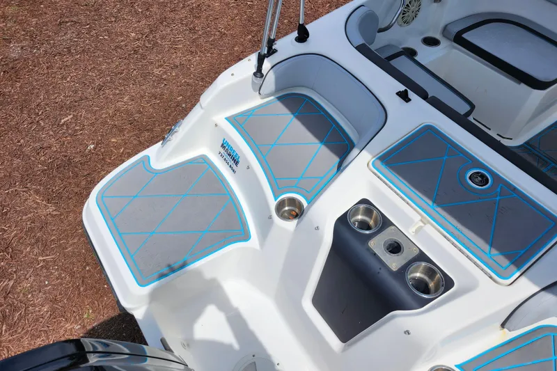 Slide: The Image of 2023 Bayliner Element M17 boat interior with blue-accented seating and cup holders. - 30