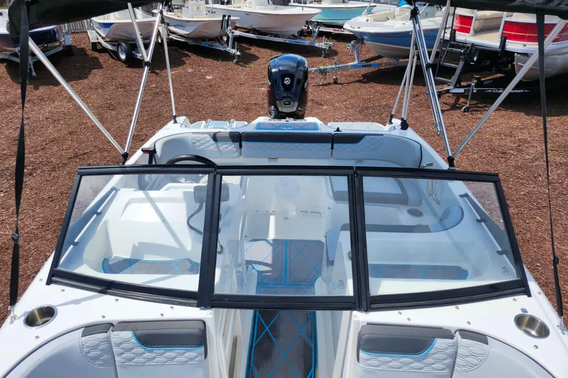 Slide: The Image of 2023 Bayliner Element M17 boat interior with seating and windshield, displayed outdoors. - 33