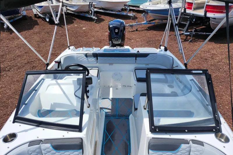 Slide: The Image of 2023 Bayliner Element M17 boat interior with seating and steering wheel, displayed outdoors. - 34