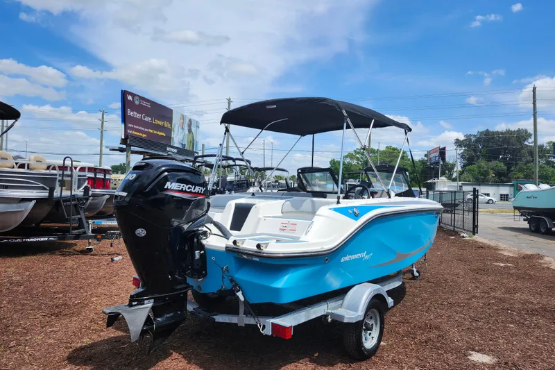 Slide: The Image of 2023 Bayliner Element M17 boat with Mercury engine on trailer, displayed outdoors. - 7