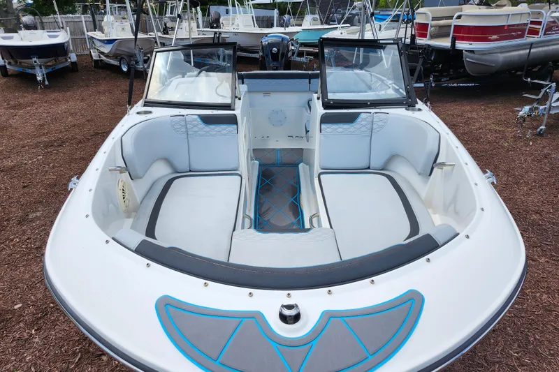 Slide: The Image of 2023 Bayliner Element M17 boat interior with seating and windshield, displayed outdoors. - 8