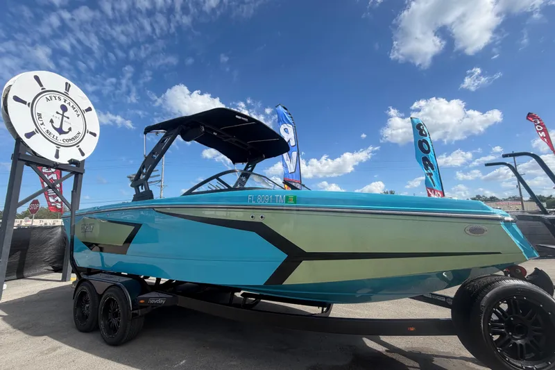 The Image of 2023 Heyday WTSurf boat in vibrant blue on display under a sunny sky. - 0