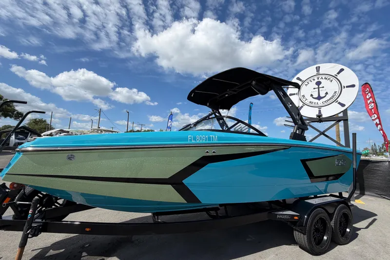 Slide: The Image of 2023 Heyday WTSurf boat in vibrant blue, displayed outdoors under a sunny sky. - 10