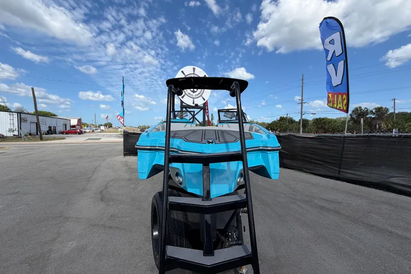 Slide: The Image of 2023 Heyday WTSurf boat on trailer, displayed outdoors under blue sky. - 11