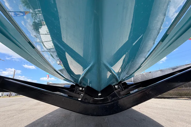 Slide: The Image of 2023 Heyday WTSurf boat in vibrant blue, showcased outdoors under a clear sky. - 14