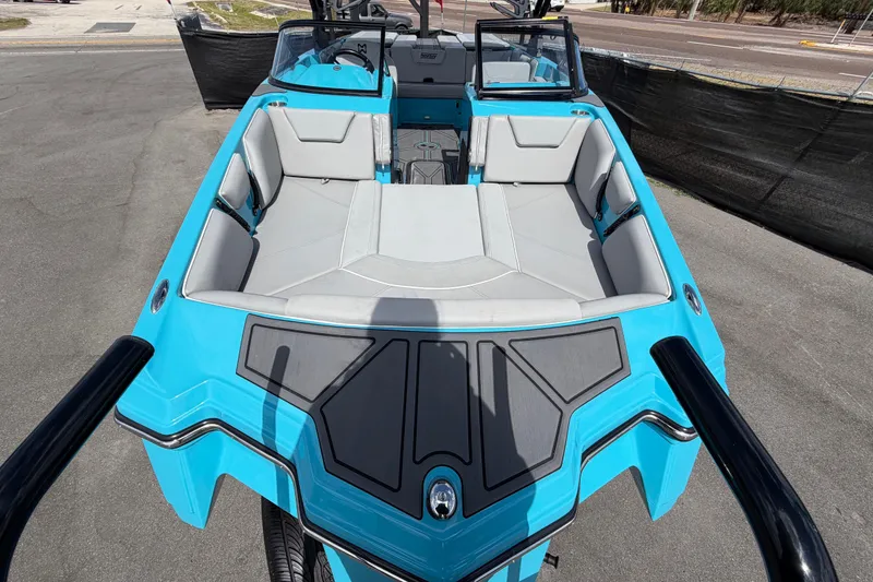 Slide: The Image of 2023 Heyday WTSurf boat with blue and gray interior, displayed outdoors under a sunny sky. - 17