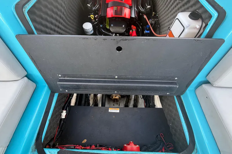 Slide: The Image of 2023 Heyday WTSurf boat engine compartment with red engine cover, open hatch. - 36