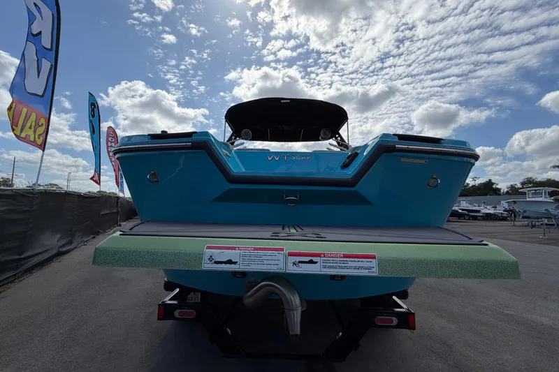 Slide: The Image of 2023 Heyday WTSurf boat displayed outdoors under a partly cloudy sky. - 4