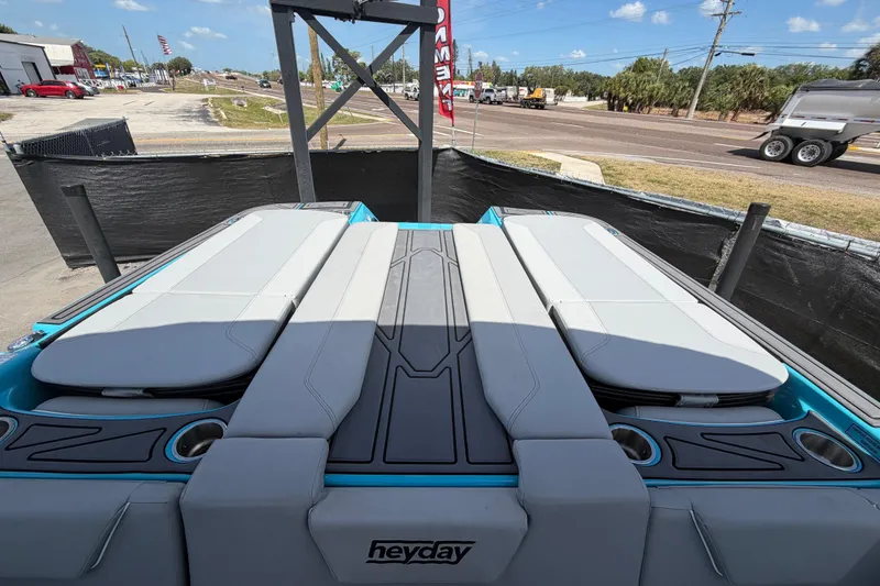 Slide: The Image of 2023 Heyday WTSurf boat interior with adjustable seating and storage, displayed outdoors. - 44