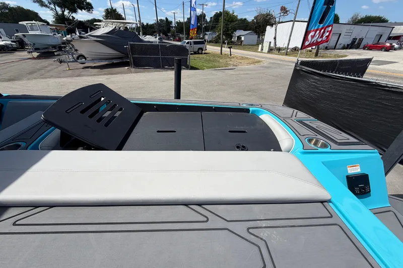 Slide: The Image of 2023 Heyday WTSurf boat interior with blue and gray seating, cup holders, and handle. - 46