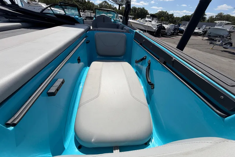 Slide: The Image of 2023 Heyday WTSurf boat with sleek seating and modern design at a marina. - 50