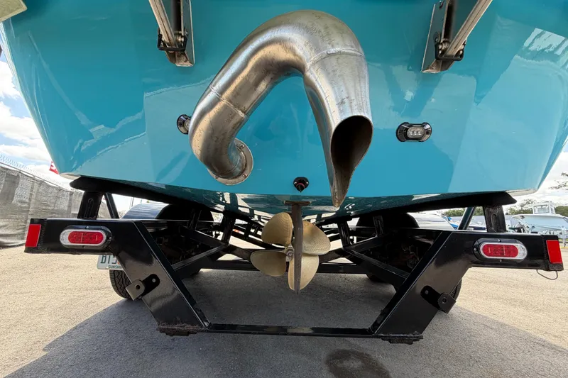 Slide: The Image of Rear view of 2023 Heyday WTSurf boat on trailer, showcasing propeller and exhaust. - 6
