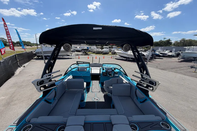 Slide: The Image of 2023 Heyday WTSurf boat interior with blue accents and modern seating. - 60