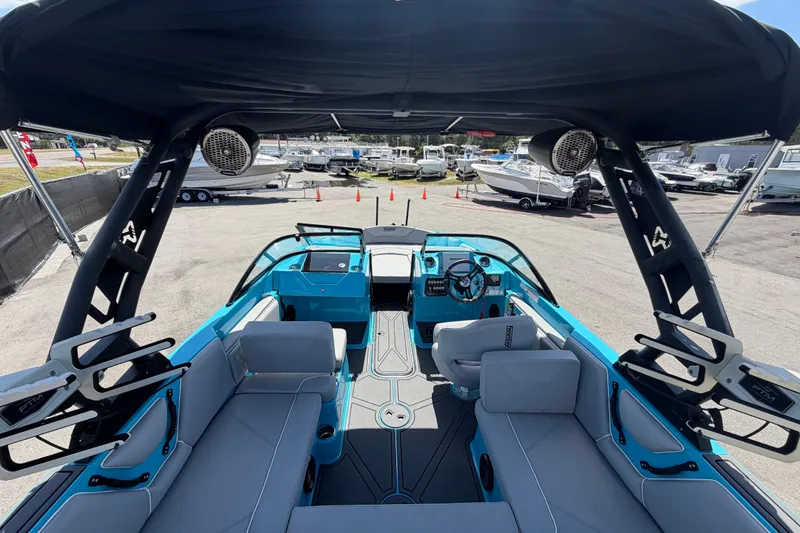 Slide: The Image of 2023 Heyday WTSurf boat interior with steering wheel and seating, docked at marina. - 61