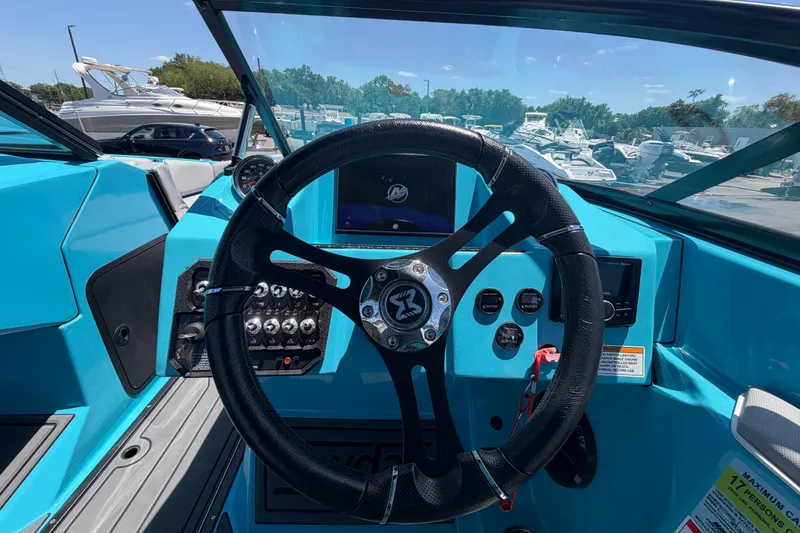 Slide: The Image of Control panel of a 2023 Heyday WTSurf boat with various switches and key ignition. - 68