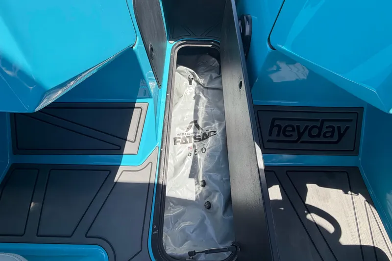 Slide: The Image of Interior view of a 2023 Heyday WTSurf boat, featuring blue panels and a speaker. - 79