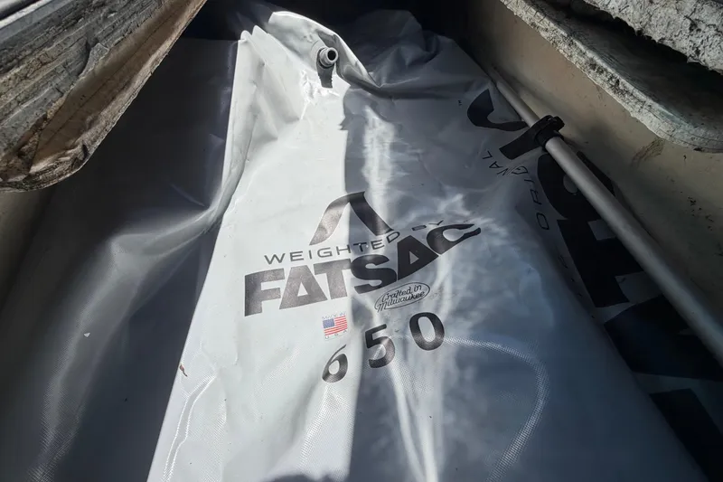 Slide: The Image of Open storage compartment on 2023 Heyday WTSurf boat, featuring a sleek blue exterior. - 80