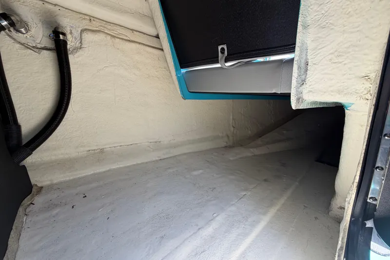 Slide: The Image of 2023 Heyday WTSurf boat interior with gray seating, parked in a marina. - 83