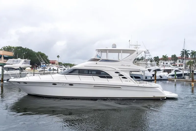 The Image of 2000 Sea Ray 560 Sedan Bridge yacht docked at marina, side view. - 0