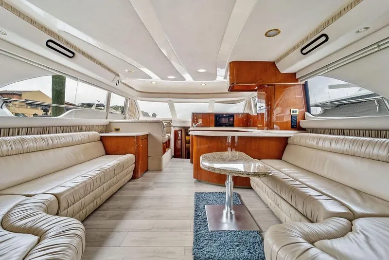 Slide: The Image of Luxurious interior of a 2000 Sea Ray 560 Sedan Bridge yacht with elegant seating and modern design. - 12