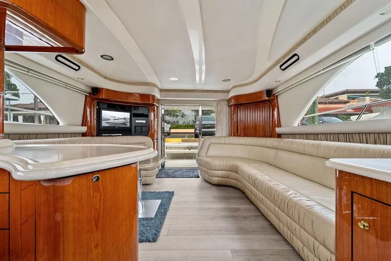 Slide: The Image of Luxurious interior of a 2000 Sea Ray 560 Sedan Bridge yacht with elegant seating and wood finishes. - 13