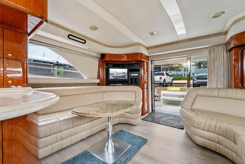 Slide: The Image of Luxurious interior of a 2000 Sea Ray 560 Sedan Bridge yacht with plush seating and elegant decor. - 14