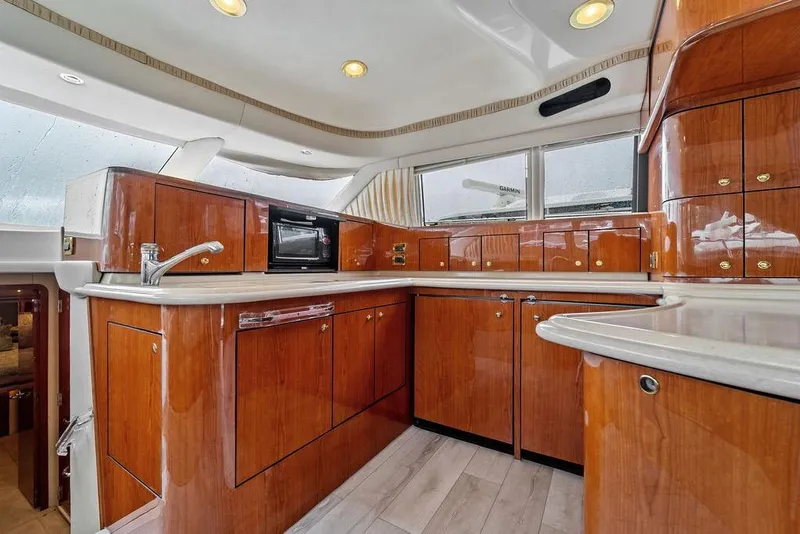 Slide: The Image of Luxurious kitchen interior of 2000 Sea Ray 560 Sedan Bridge yacht with wood cabinetry. - 15