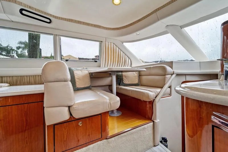 Slide: The Image of Luxurious interior of 2000 Sea Ray 560 Sedan Bridge yacht with plush seating and elegant wood finishes. - 16
