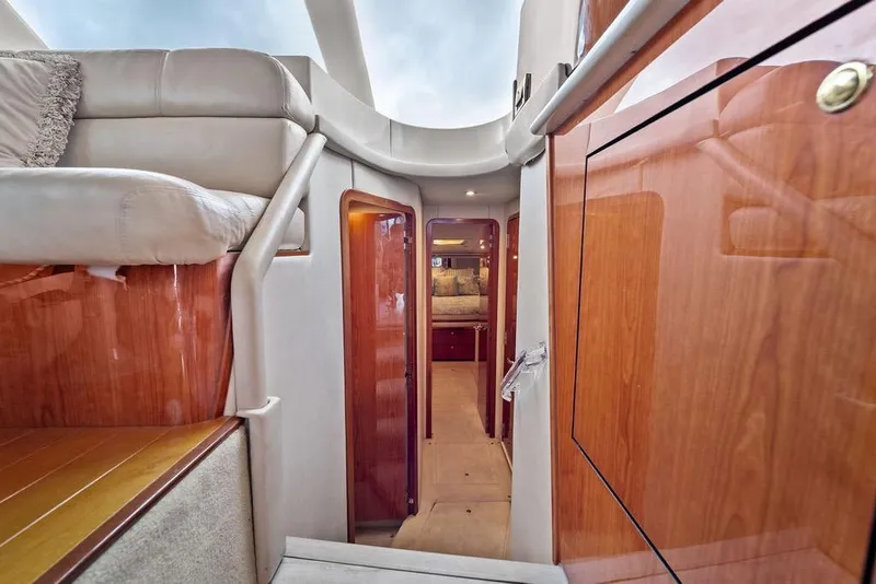 Slide: The Image of Interior view of 2000 Sea Ray 560 Sedan Bridge yacht, featuring elegant wood finishes and plush seating. - 19