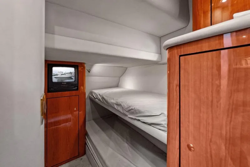 Slide: The Image of Interior cabin of 2000 Sea Ray 560 Sedan Bridge with bunk beds and TV. - 20