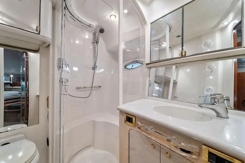 Slide: The Image of Luxurious bathroom in 2000 Sea Ray 560 Sedan Bridge yacht, featuring shower and vanity. - 24