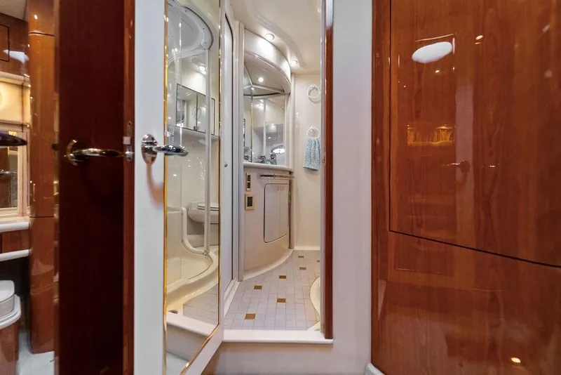 Slide: The Image of Luxurious bathroom interior of 2000 Sea Ray 560 Sedan Bridge yacht with wood accents. - 26